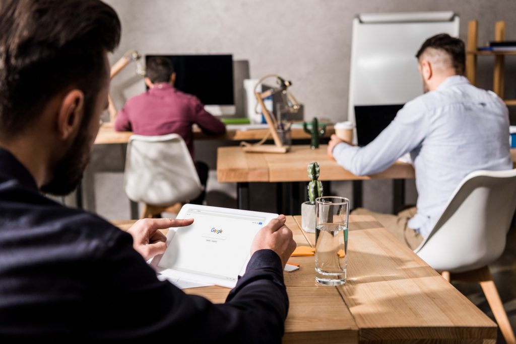 businessman holding tablet with loaded google page
